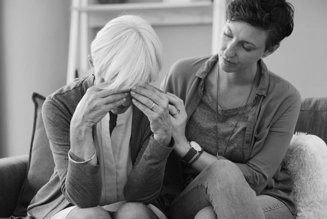 Elderly woman with Alzheimer's Disease and daughter caring for her